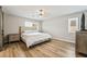 Bright main bedroom featuring a ceiling fan, shutters, and a light wood-look floor at 10565 Olinda St, Las Vegas, NV 89179