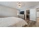 Bright main bedroom featuring a ceiling fan, shutters, wood-look flooring, and a walk-in closet at 10565 Olinda St, Las Vegas, NV 89179