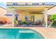 Inviting covered patio with comfortable seating and a sparkling pool, perfect for outdoor relaxation at 10823 Drake Ridge Ave, Las Vegas, NV 89166