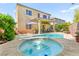 Inviting backyard features a sparkling pool, hot tub, covered patio and lush landscaping perfect for outdoor living at 10823 Drake Ridge Ave, Las Vegas, NV 89166