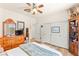Bedroom with laminate flooring, view to backyard, built in bookcase and mirrored closets at 10823 Drake Ridge Ave, Las Vegas, NV 89166