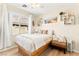 Bright bedroom with a queen bed, decor shelving and a view of the outdoors at 10823 Drake Ridge Ave, Las Vegas, NV 89166