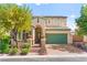 Charming two-story home with a well-manicured lawn, brick accents, green doors, and an attached two-car garage at 10823 Drake Ridge Ave, Las Vegas, NV 89166