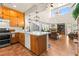 Modern kitchen featuring a spacious island, light wood cabinets, stainless steel appliances, and an open floor plan at 10823 Drake Ridge Ave, Las Vegas, NV 89166