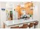 Modern kitchen features a spacious island with bar stool seating, quartz countertops, and ample cabinet space at 10823 Drake Ridge Ave, Las Vegas, NV 89166