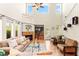 Spacious living room with fireplace, high ceilings and view to a pool at 10823 Drake Ridge Ave, Las Vegas, NV 89166