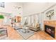 Bright living room with a fireplace, large windows, high ceilings, and stylish decor creates an inviting atmosphere at 10823 Drake Ridge Ave, Las Vegas, NV 89166
