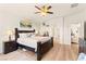 Spacious main bedroom featuring wood floors, ceiling fan, and connecting doors at 10823 Drake Ridge Ave, Las Vegas, NV 89166