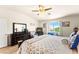 Comfortable main bedroom with a ceiling fan, wood floors, and window view at 10823 Drake Ridge Ave, Las Vegas, NV 89166