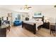 Spacious main bedroom featuring a ceiling fan, wood floors, and a window at 10823 Drake Ridge Ave, Las Vegas, NV 89166