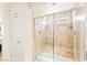 Shower with glass doors, tile surround, and a built-in bench at 10823 Drake Ridge Ave, Las Vegas, NV 89166