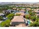 High angle aerial view of a home with a backyard pool, mature landscaping, and picturesque mountain views at 11237 Campsie Fells Ct, Las Vegas, NV 89141