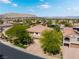 Wide aerial view of a beautiful home featuring lush landscaping, a long driveway, and serene mountain views in the background at 11237 Campsie Fells Ct, Las Vegas, NV 89141