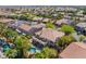 Aerial view of home featuring a balcony overlooking a custom pool, mature trees, and landscaped backyard at 11237 Campsie Fells Ct, Las Vegas, NV 89141