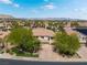 Expansive aerial view of a home showcasing its well-maintained landscaping, long driveway, and mountain views in the distance at 11237 Campsie Fells Ct, Las Vegas, NV 89141