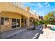 A covered patio with views of the pool, lush landscaping, and outdoor living spaces at 11237 Campsie Fells Ct, Las Vegas, NV 89141