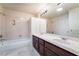 Primary bathroom with double sink vanity and tiled shower and tub with lots of light from the overhead at 11237 Campsie Fells Ct, Las Vegas, NV 89141