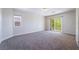 Bedroom featuring plush carpet, neutral walls, and sliding glass door access to a balcony at 11237 Campsie Fells Ct, Las Vegas, NV 89141