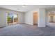 Bedroom featuring plush carpet, light neutral walls, a walk-in closet, and sliding door access to a balcony at 11237 Campsie Fells Ct, Las Vegas, NV 89141