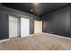 A comfortable bedroom with an open closet, neutral carpeting, and access to another room at 11237 Campsie Fells Ct, Las Vegas, NV 89141