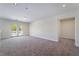 Bonus room with neutral carpet and sliding glass doors to the balcony at 11237 Campsie Fells Ct, Las Vegas, NV 89141