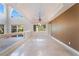 Open-concept dining room featuring tile flooring, clerestory windows, and a modern chandelier at 11237 Campsie Fells Ct, Las Vegas, NV 89141