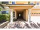 Elegant entryway with pillars leading to a double-door entrance and a view of the three-car garage at 11237 Campsie Fells Ct, Las Vegas, NV 89141