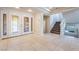 Bright foyer featuring tile flooring, a staircase, and a view of the decorative glass front doors at 11237 Campsie Fells Ct, Las Vegas, NV 89141