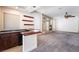 Open living room with wet bar, fireplace, and modern design features at 11237 Campsie Fells Ct, Las Vegas, NV 89141