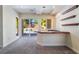 Bright living room with bar and sliding glass doors to the pool at 11237 Campsie Fells Ct, Las Vegas, NV 89141