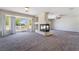 Bright living room with fireplace, large windows, and access to a balcony at 11237 Campsie Fells Ct, Las Vegas, NV 89141