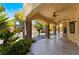 Spacious covered patio with stone pillars, ceiling fans, and views of the backyard pool and lush landscaping at 11237 Campsie Fells Ct, Las Vegas, NV 89141