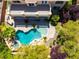 Aerial view of backyard oasis featuring a custom pool, spa, mature trees, and spacious patio area at 11237 Campsie Fells Ct, Las Vegas, NV 89141