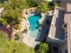 Aerial view of backyard oasis featuring a custom pool, spa, mature trees, and spacious patio area at 11237 Campsie Fells Ct, Las Vegas, NV 89141