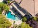 Aerial view of backyard oasis featuring a custom pool, spa, mature trees, and spacious patio area at 11237 Campsie Fells Ct, Las Vegas, NV 89141
