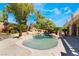 Tranquil pool area with rock waterfall features and palm trees, creating a serene backyard oasis at 11237 Campsie Fells Ct, Las Vegas, NV 89141
