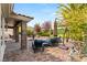 Lush backyard featuring a brick patio with a fountain, seating areas, and mature trees at 11578 Suburban Rd, Las Vegas, NV 89135