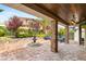 Beautiful backyard patio with brick flooring, seating area, fountain, and lush landscaping at 11578 Suburban Rd, Las Vegas, NV 89135