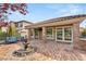 Elegant backyard patio with a fountain, brick columns, lounge furniture, and tile roofing at 11578 Suburban Rd, Las Vegas, NV 89135