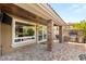 Backyard patio with brick pillars, an outdoor dining area, and built-in barbecue at 11578 Suburban Rd, Las Vegas, NV 89135