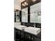 Elegant bathroom with double sinks, modern lighting, and decorative backsplash, enhancing the room's luxurious feel at 11578 Suburban Rd, Las Vegas, NV 89135