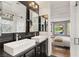 Stunning bathroom featuring double sinks, black countertops, and direct view of a bedroom with an outdoor backyard at 11578 Suburban Rd, Las Vegas, NV 89135