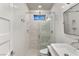 Bright bathroom with a glass-enclosed shower, featuring white tile, and modern fixtures enhancing the room's functionality at 11578 Suburban Rd, Las Vegas, NV 89135