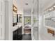 Modern bathroom featuring double sinks, marble floors, and a glass-enclosed shower with a view to the bedroom at 11578 Suburban Rd, Las Vegas, NV 89135