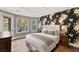 Spacious bedroom boasts floral wallpaper, hardwood floors, and access to the outdoor patio at 11578 Suburban Rd, Las Vegas, NV 89135
