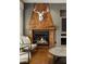 Close up on the fireplace, surrounded by rustic wood detailing and decor at 11578 Suburban Rd, Las Vegas, NV 89135