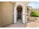 Stylish front entrance with arched doorway and brick-paved landing at 11578 Suburban Rd, Las Vegas, NV 89135