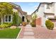 Inviting front yard featuring manicured landscaping, artificial turf, and a stone pathway at 11578 Suburban Rd, Las Vegas, NV 89135