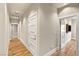 Hallway features hardwood floors, neutral walls, white trim, and access to multiple rooms at 11578 Suburban Rd, Las Vegas, NV 89135