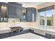 Gourmet kitchen features stainless steel appliances, a farmhouse sink, and marble countertops at 11578 Suburban Rd, Las Vegas, NV 89135